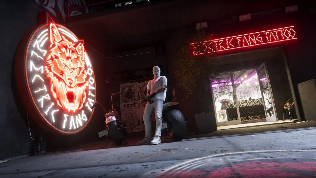 The Electric Fang Tattoo storefront at night in GTA 6, with a red neon wolf sign, a masked figure leaning on a motorcycle and the open shop door. Official Rockstar Games screenshot.