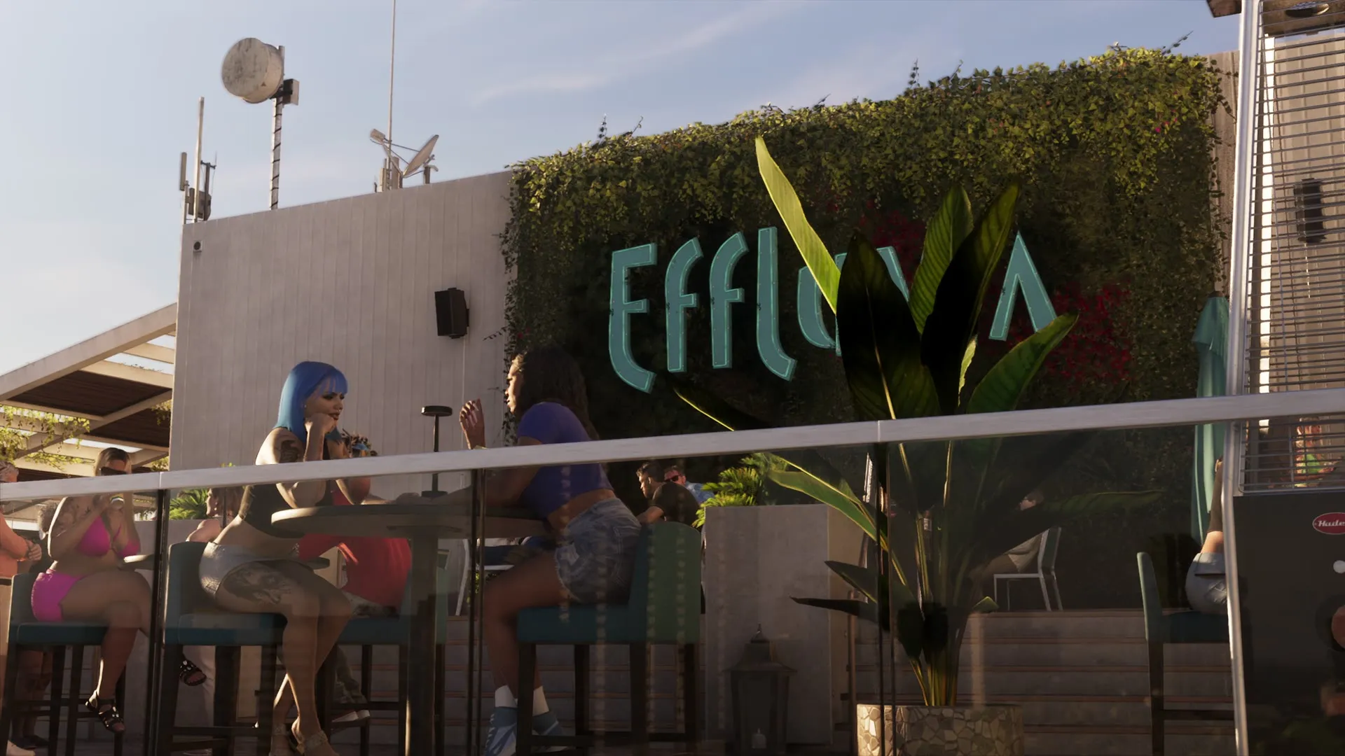The Effluvia rooftop bar in Vice City in GTA 6 An Extended Look, its teal sign on a plant-covered wall behind customers sitting at high tables in the sun. Still from Rockstar Games' official video.