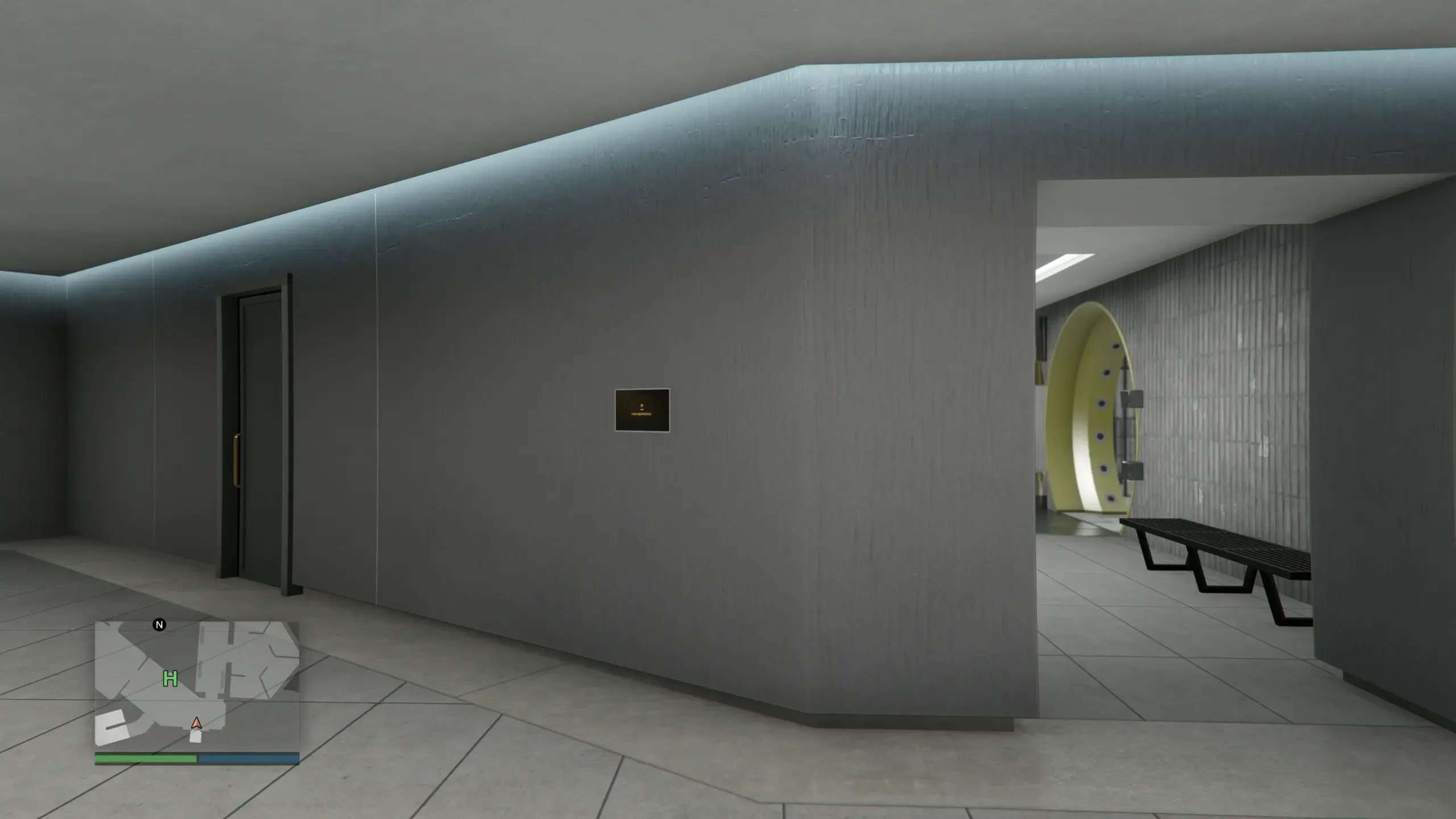Basement Level 2 corridor in a GTA Online Mansion with the Art Studio door on the left wall, a minimap in the bottom-left corner showing a green H marker, and the Mansion vault further down the corridor on the right, its round yellow door standing open with a bench outside