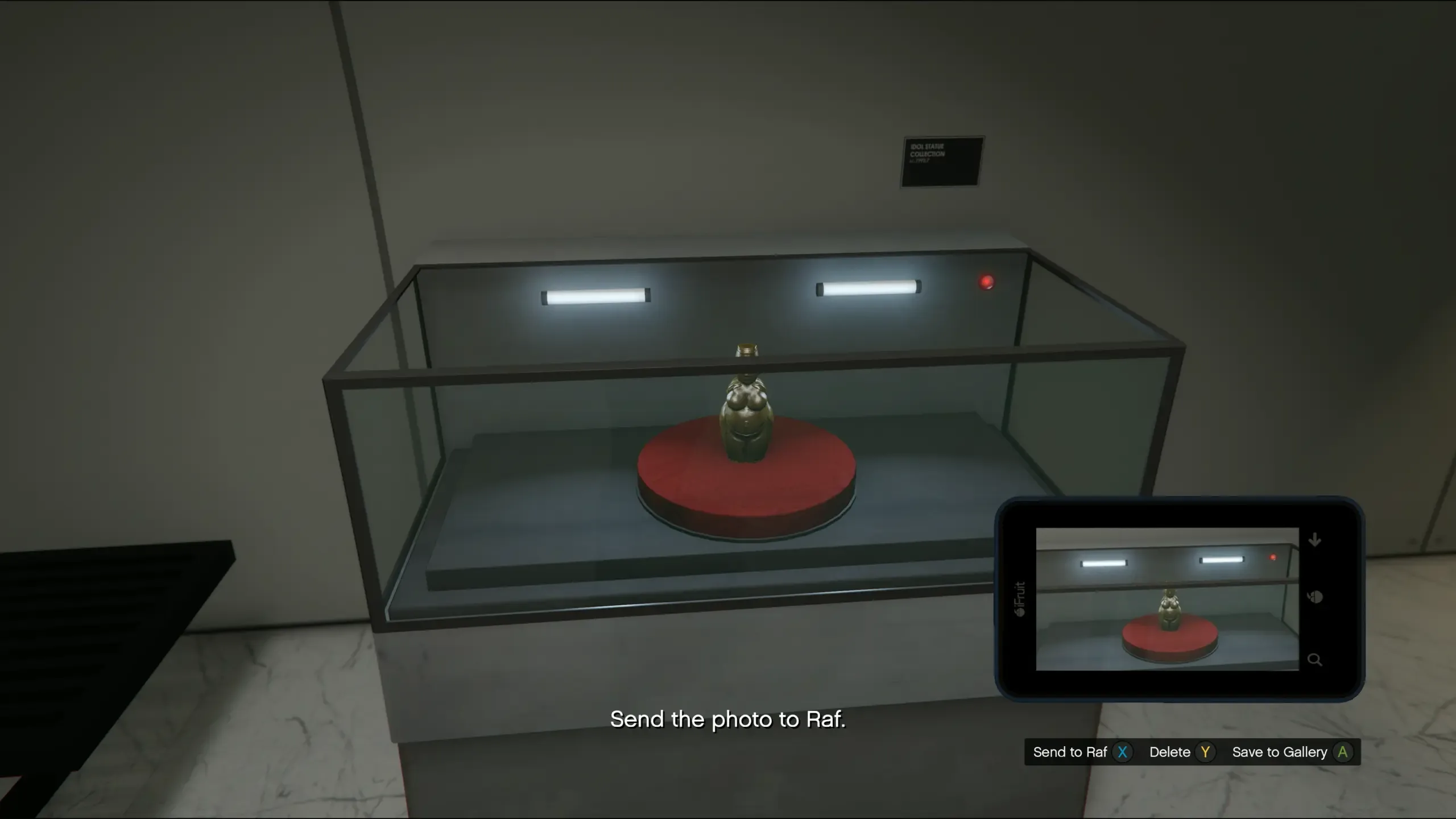 A reinforced glass display case with a red light inside, holding an idol statue in the Kortz Center exhibition